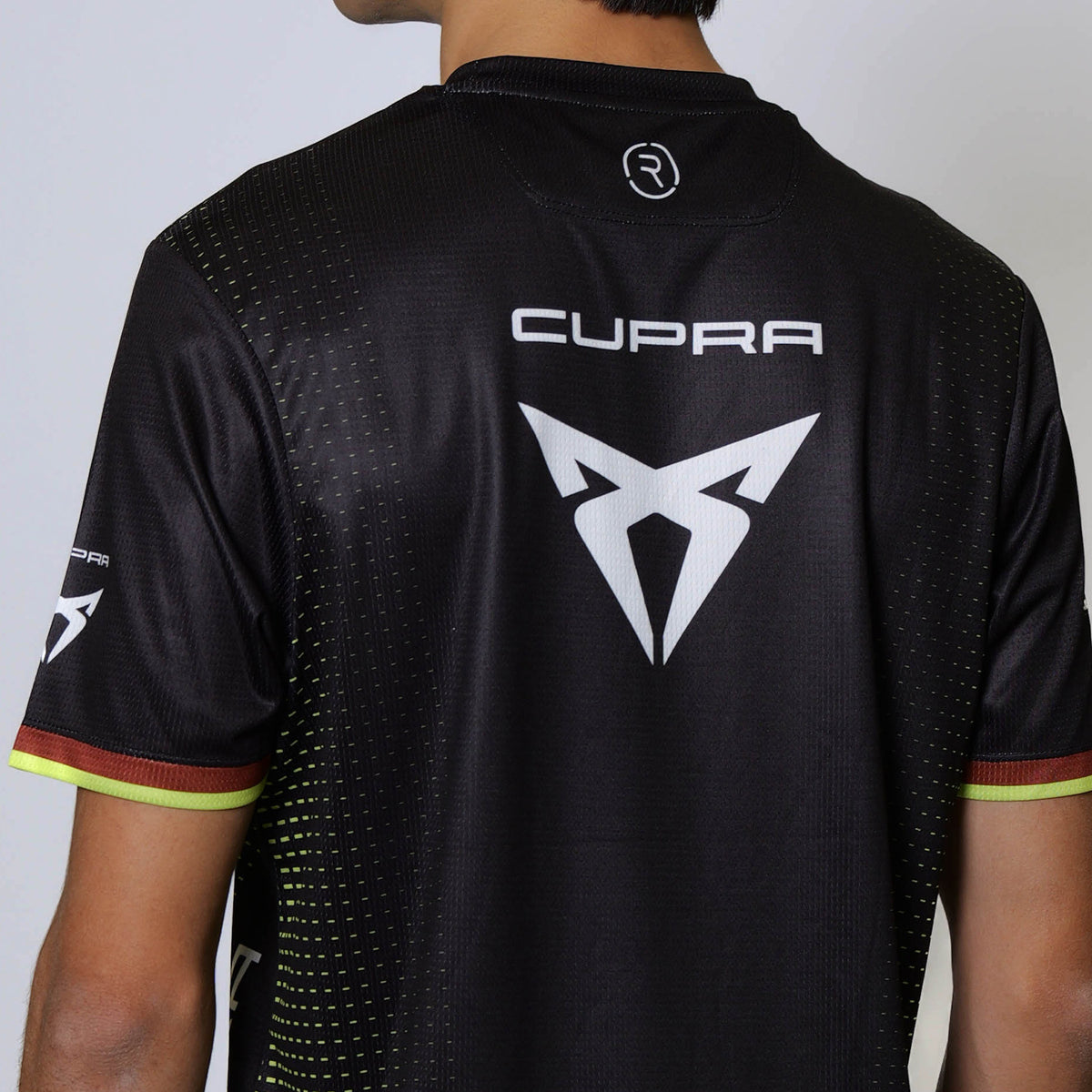 A man wearing a black Cupra Kiro t-shirt made by Reflo