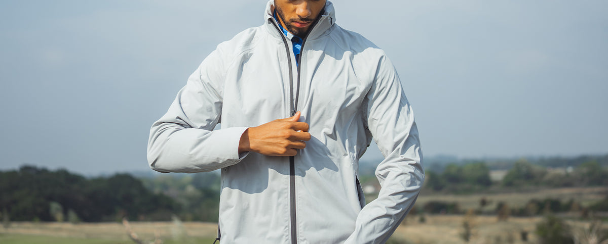 A man wearing a Reflo jacket while playing golf