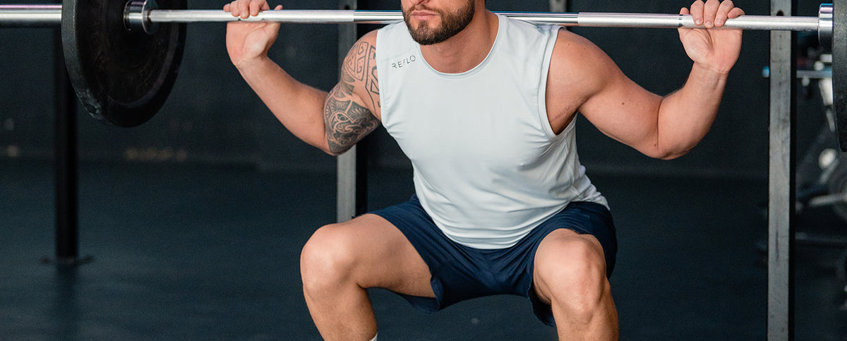 A man wearing a Reflo tank while doing his gym session